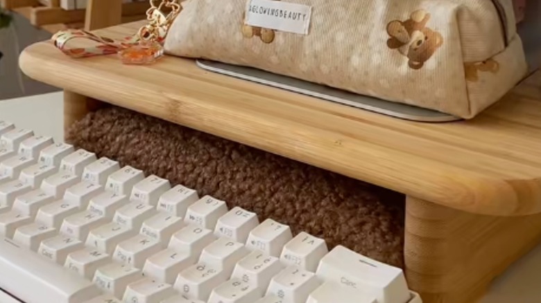 IKEA wood cutting board used as a monitor riser on desktop