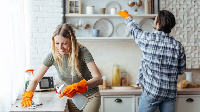 couple cleaning the kitchen