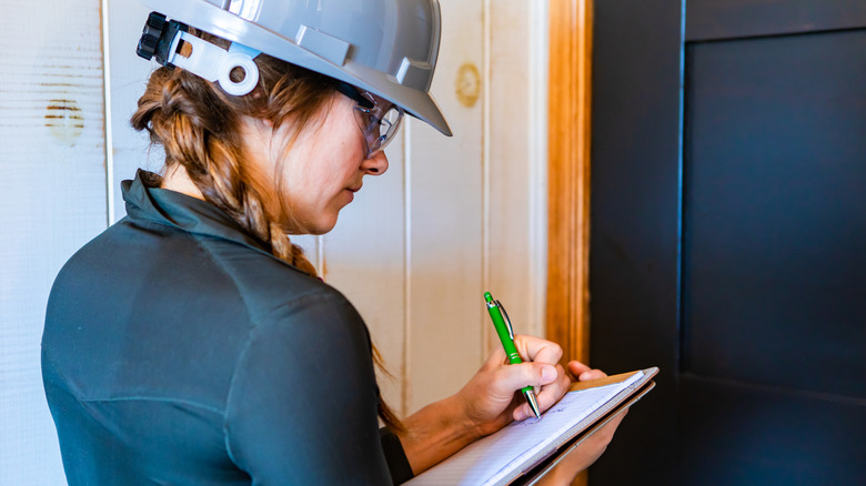 woman inspecting home