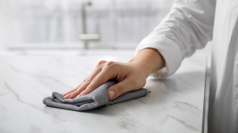 person cleaning marble