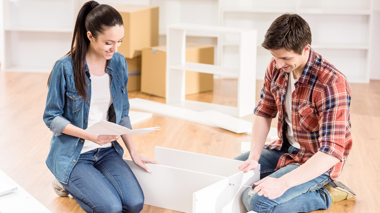 couple assembles furniture