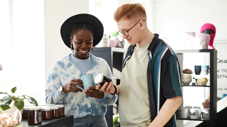 couples shopping for unique dinnerware in a thrift shop