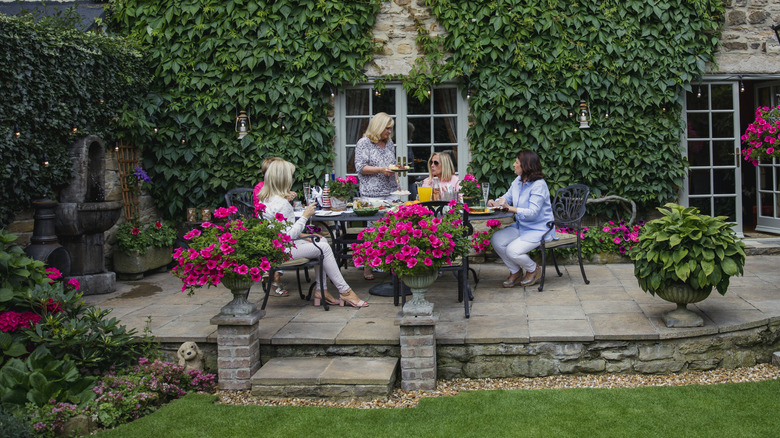 a group of women enjoying lunch in the garden