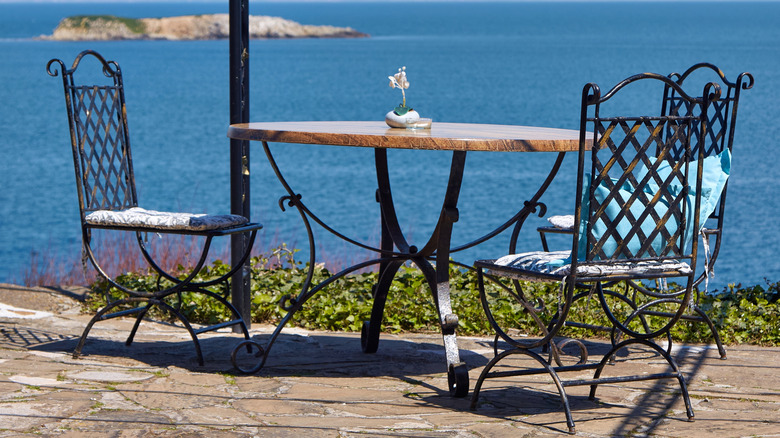 Wrought iron table and chairs in a coastal setting