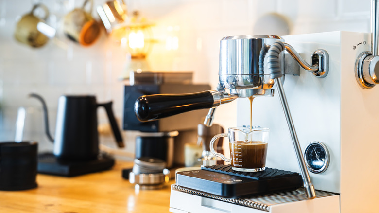 Home coffee station with espresso machine making coffee