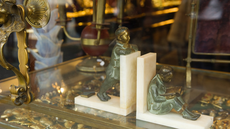 patina'd bookends along with other items at a second hand store