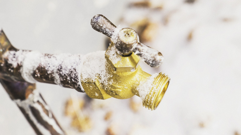 A frozen spigot with ice and snow on it