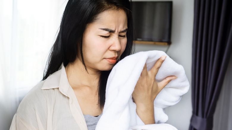 Woman smelling clothes