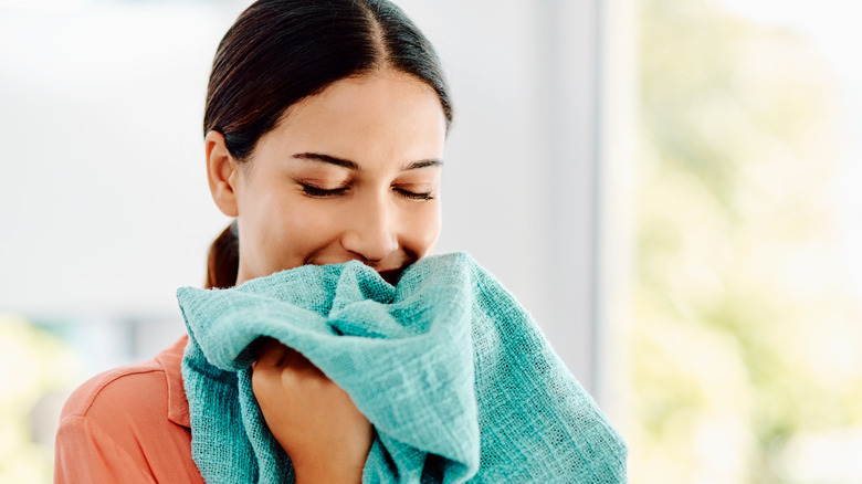 Woman smelling fresh clothing item