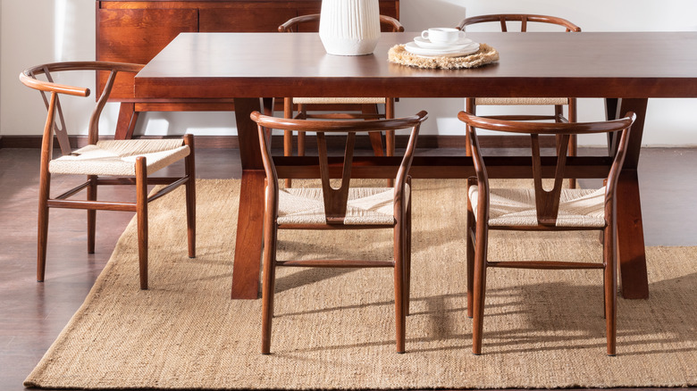 Warm and inviting dining room with area rug under table