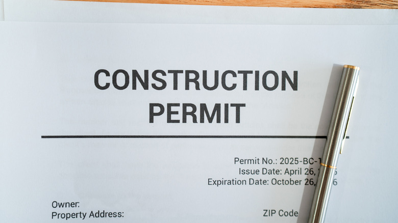 A document titled "construction permits" on a table