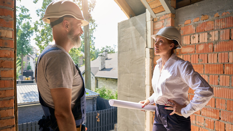 Two home improvement experts speaking with each other