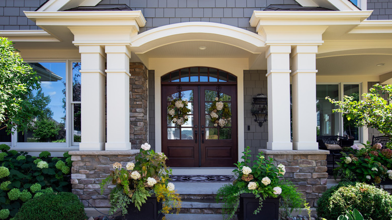 A large-scale double door with architectural transom and columns