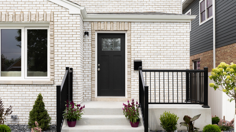 White brick home with black front door