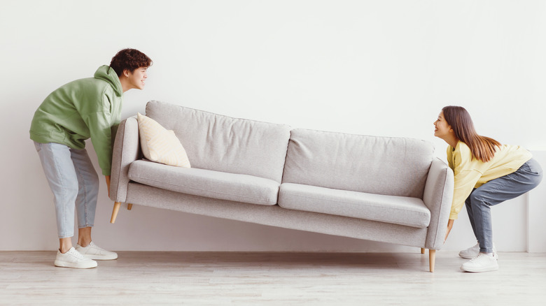 Couple moving a couch
