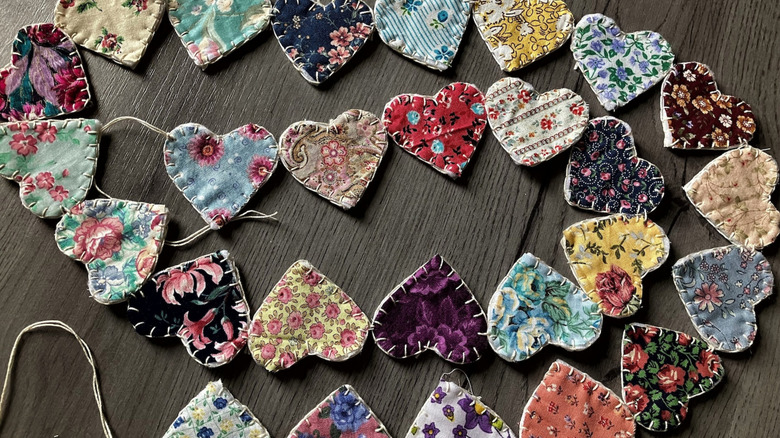 A stitched heart garland filled with dozens of hearts in different patterns with big white stitches