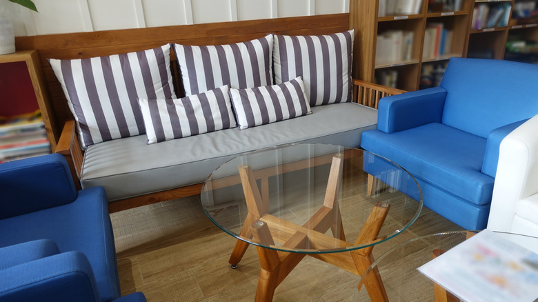 living space with glass top coffee table in the center of seating arrangements