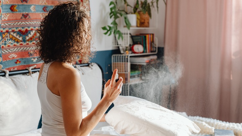 Woman using room spray