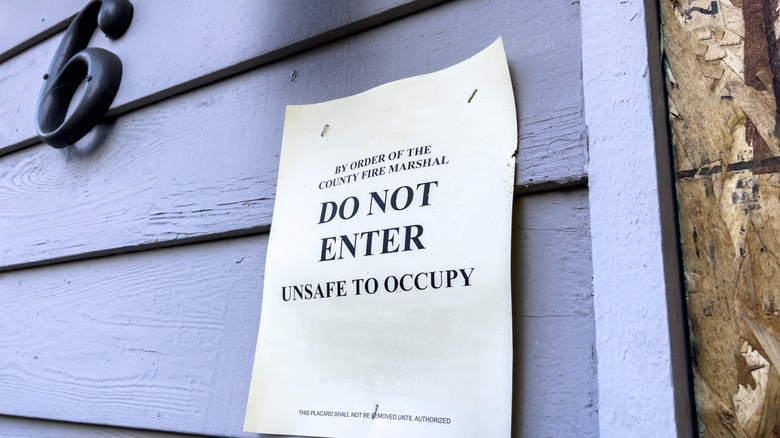 A warning notice on the exterior of a condemned house