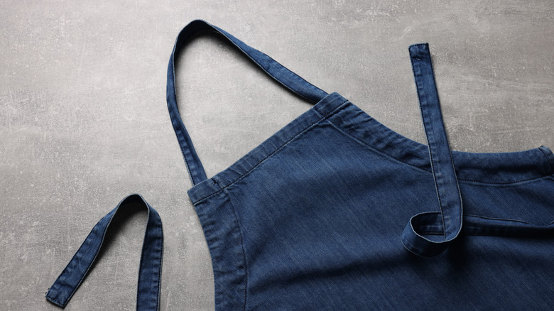 A denim apron laid flat