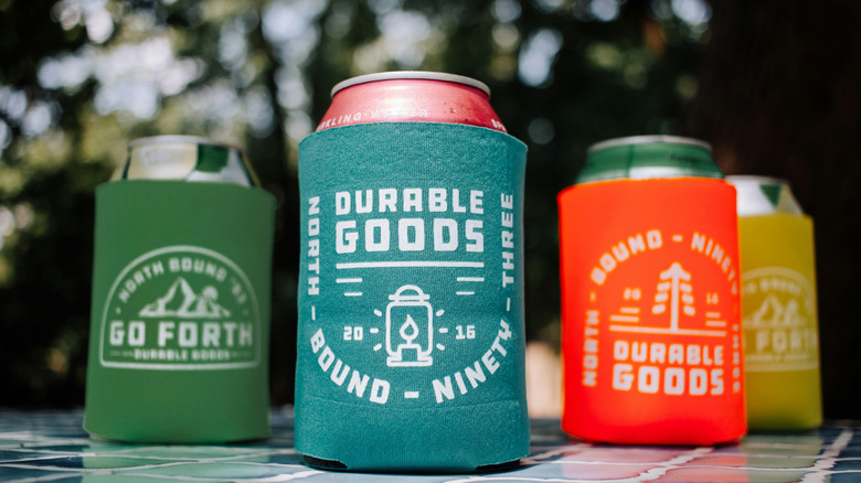 Cans in koozies on a table