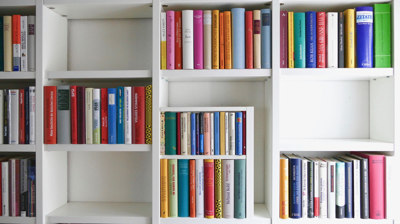 White cubby-style bookcase with a mix of empty shelves and full shelves.