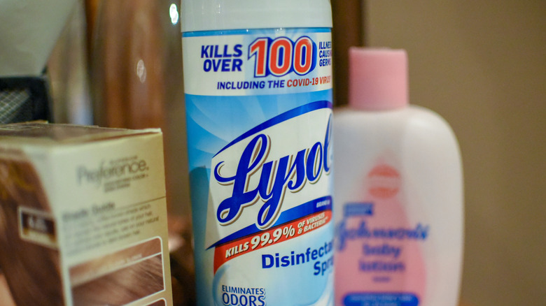 Bottle of Lysol disinfecting spray sitting on a dresser