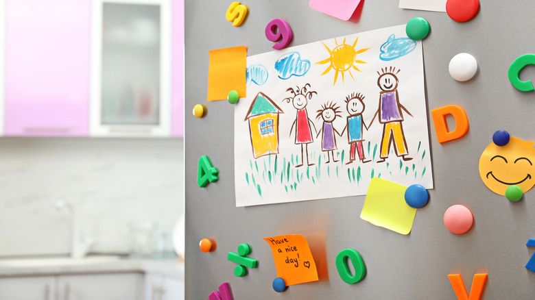 Magnets and drawings on refrigerator door