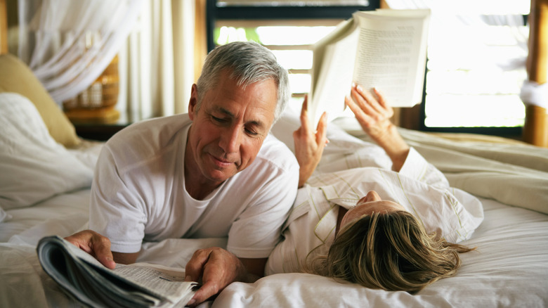 Couple relaxing in bed reading