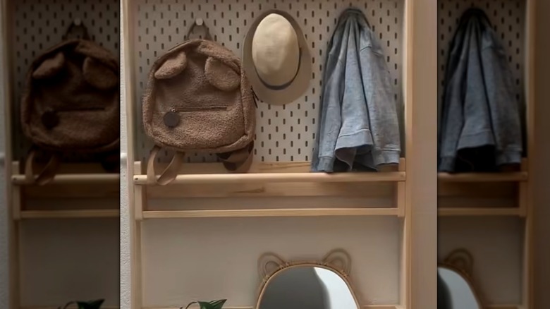 IKEA shelves and pegboards are assembled into a thin structure that holds items behind a door