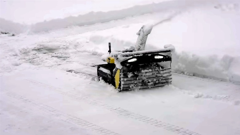 Yarbo robot snow blower clearing residential driveway