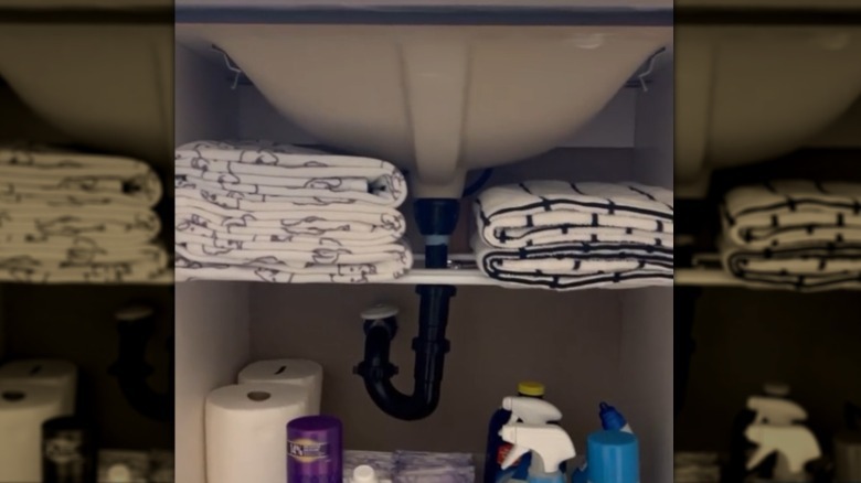 Towels stacked under the sink