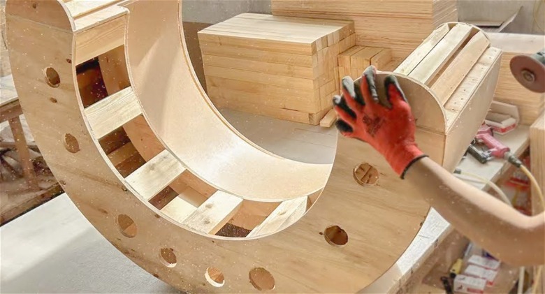 Person holding curved frame of couch