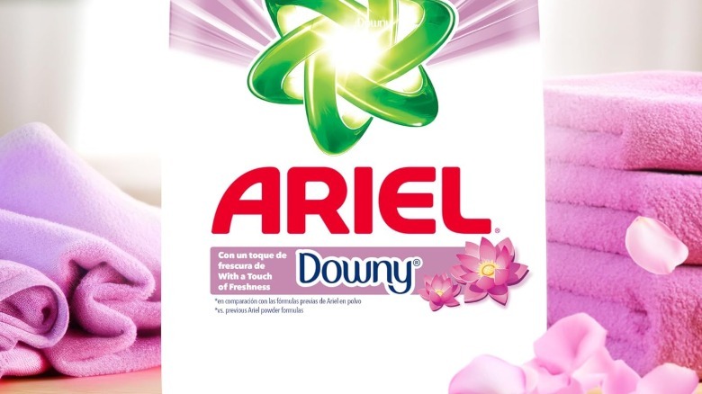 A close up of an Ariel with a touch of Downy bad in front of pink towels
