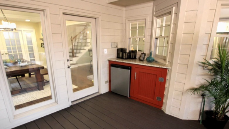 Bright patio with small red cabinet
